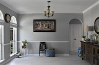 a room with gray walls and a white dresser