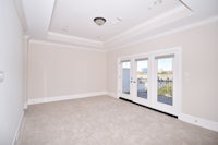 empty room with sliding glass doors and beige carpet