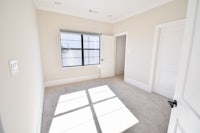 an empty room with white walls and a window