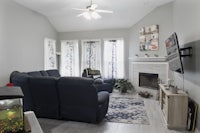 a living room with a blue couch and tv