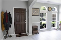 a hallway with a door and a coat rack